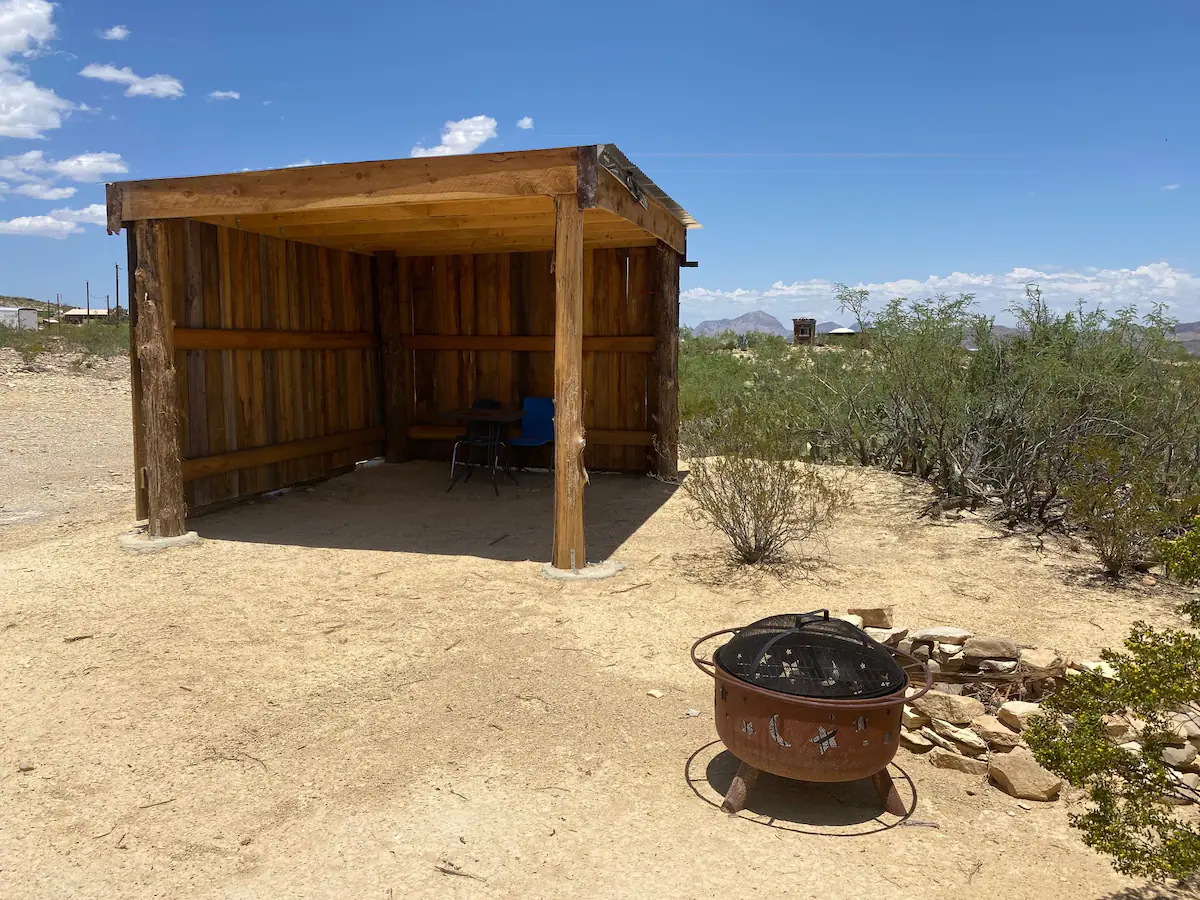 A fire pit in the middle of an open desert.