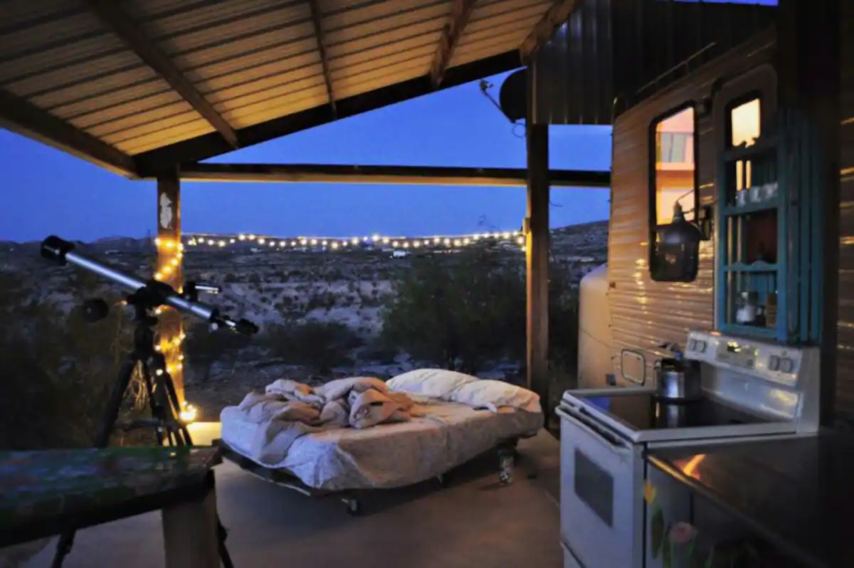 A bed in the middle of an outdoor patio.